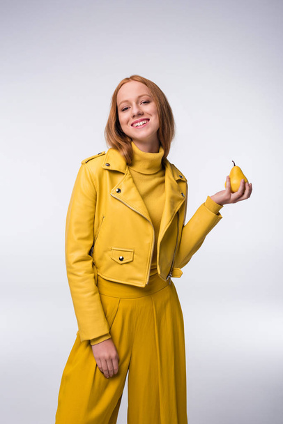 girl in yellow clothes with pear - Фото, изображение