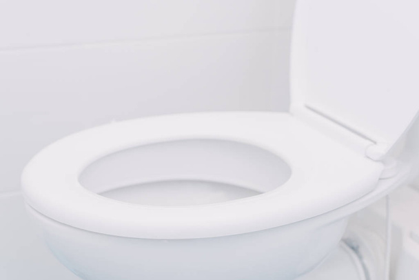 White toilet seat in bathroom - Фото, зображення