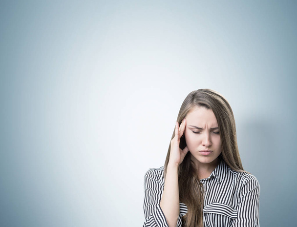 Stressed businesswoman with a headache, gray - Fotoğraf, Görsel