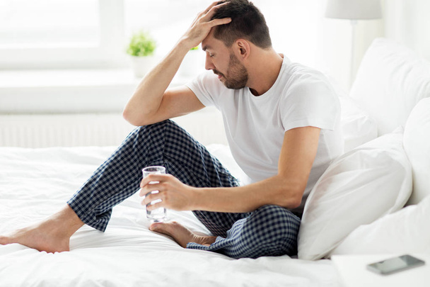 man in bed with glass of water at home - Photo, Image