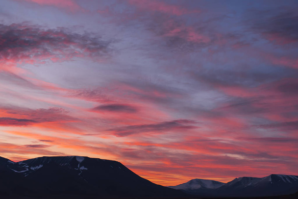 Landscape travel of a nature of a sunset sunrise with clouds in the mountains of Spitsbergen Svalbard near the Norwegian city Longyearbyen - Zdjęcie, obraz