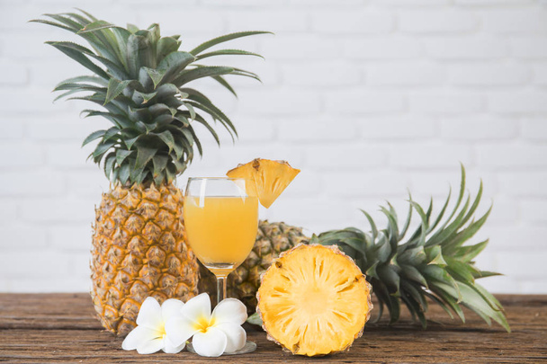 Glass of pineapple juice onwood table - Φωτογραφία, εικόνα
