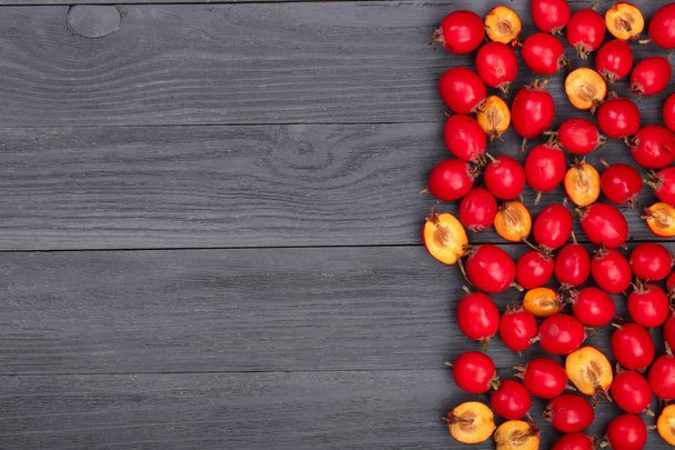 Hawthorn berry on a black wooden background with copy space for your text. Top view - Fotoğraf, Görsel