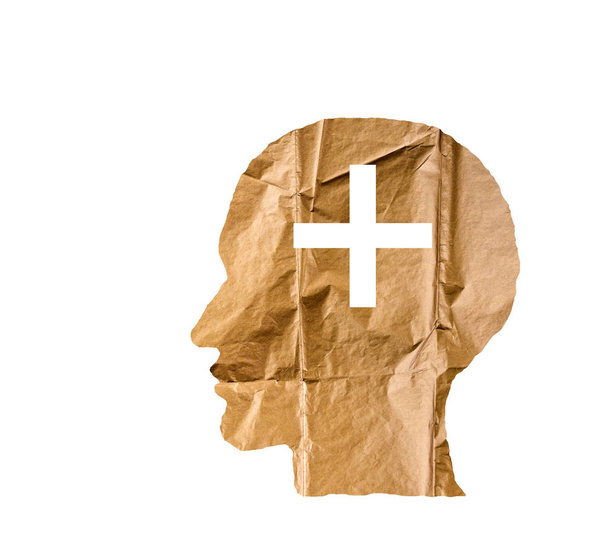 Crumpled paper shaped as a human head and plus sign on white. - Foto, imagen