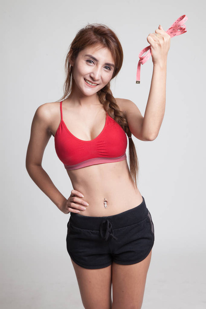 Beautiful Asian healthy girl with measuring tape. - Фото, зображення