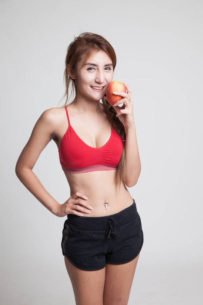 Beautiful Asian healthy girl with apple. - Zdjęcie, obraz
