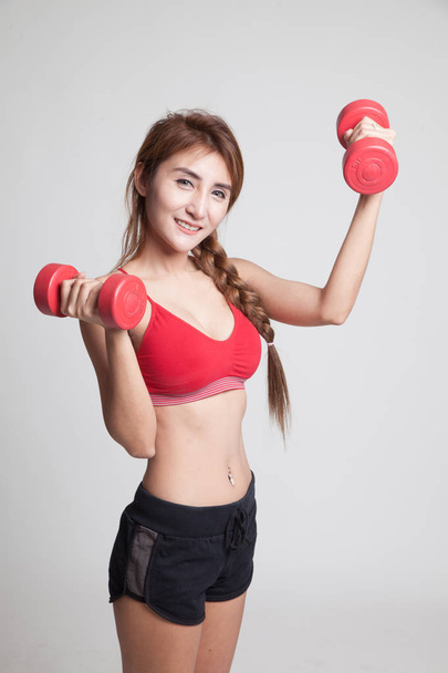 Beautiful Asian healthy girl exercise with dumbbell. - Foto, afbeelding