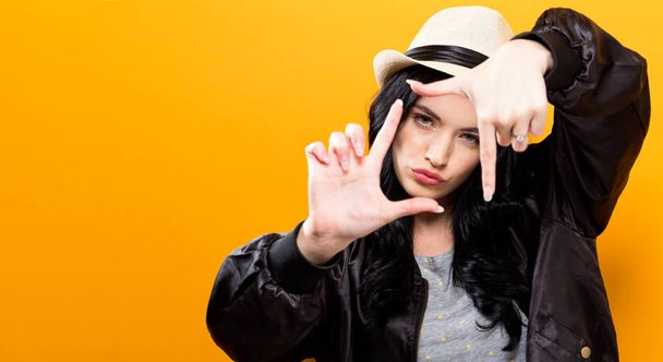  Young woman framing her face with her fingers  - Photo, image