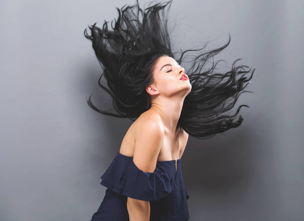 Young woman with floating hair  - Fotoğraf, Görsel