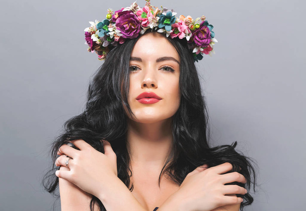 Beautiful young woman with a garland  - Foto, afbeelding