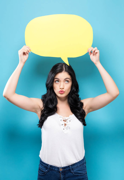 Young woman holding a speech bubble  - 写真・画像