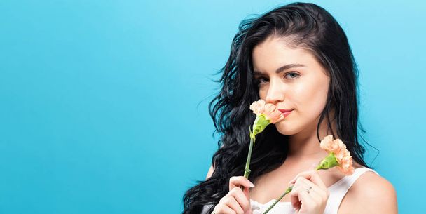  Young woman with carnation - Foto, Imagen