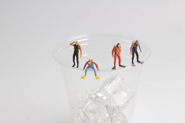 tiny divers on  the cup of ice - Photo, Image