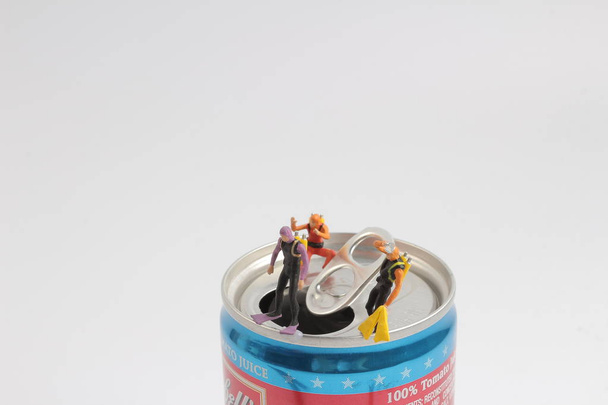 small  diver stands on an open aluminum can - Photo, Image