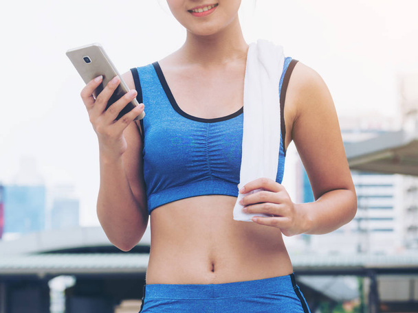 Sport woman runner using smartphone - Photo, Image