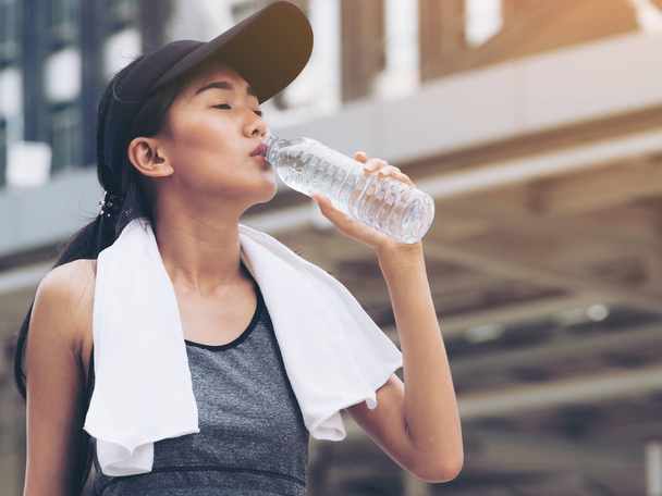 Спортивная женщина с бутылкой питьевой воды
 - Фото, изображение