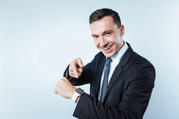 Confident man pointing toward electronic wrist watch - Фото, зображення