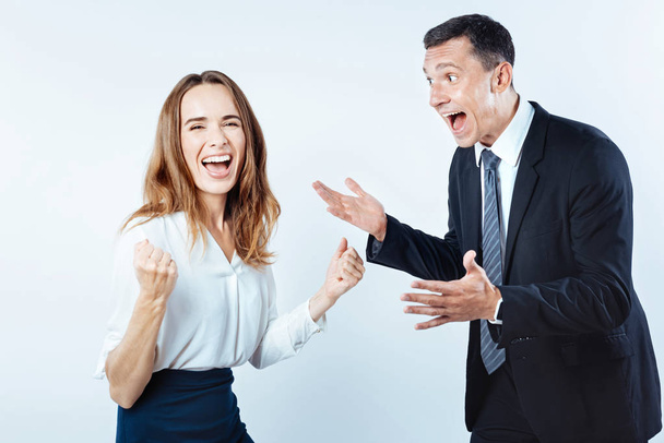 Very emotional coworkers getting excited together - 写真・画像