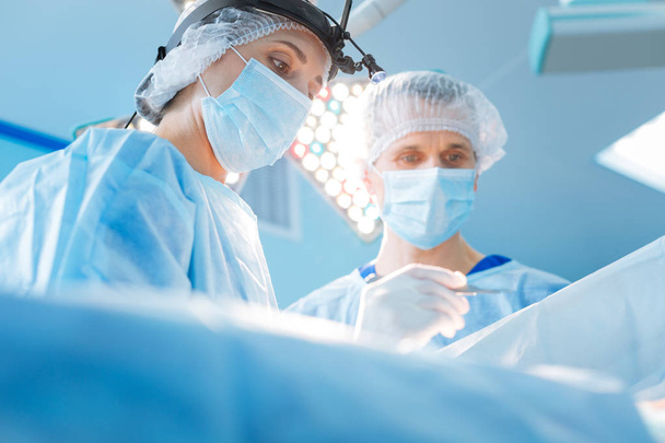 Serious surgeon being at his workplace - Photo, Image