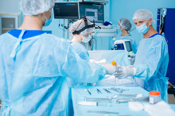 Attentive surgeon taking sterile scissors - Photo, image