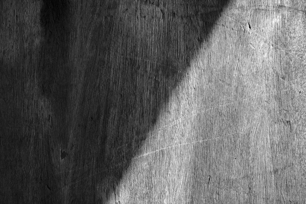 Symmetric shadow on wooden wall, monotone photograph - 写真・画像
