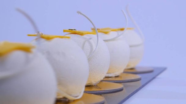 Velvet cake balls with sugar sprinkles. White, ball-shaped cakes. Decorative white cakes - Photo, Image