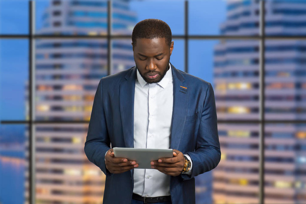 Handsome businessman holding computer tablet. - Zdjęcie, obraz
