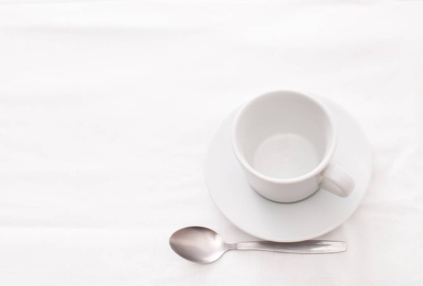 Empty white Cup of tea with spoon on white - Foto, Imagem