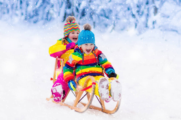 Les enfants jouent dans la neige. Randonnée en traîneau d'hiver pour enfants
 - Photo, image
