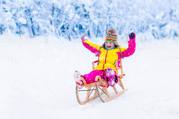 Kids play in snow. Winter sleigh ride for children - Photo, Image