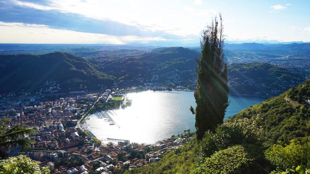 Amazing sight of Lake Como from Brunate, panoramic view of the lake and the city of Como with sun rays reflecting on the surface of the lake, Como, Lombardy, Italy - Photo, Image
