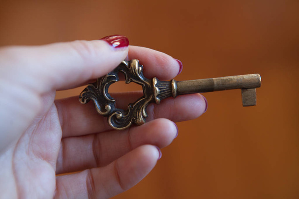 hand holding metal old key - Фото, изображение