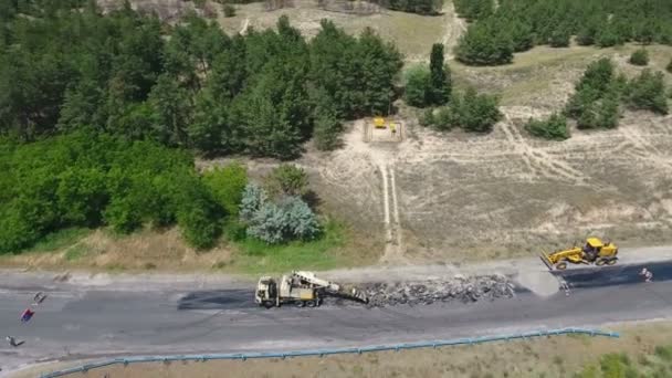 Aerial shot of a highway blacktopping, excavating, and repairing in summer - Footage, Video