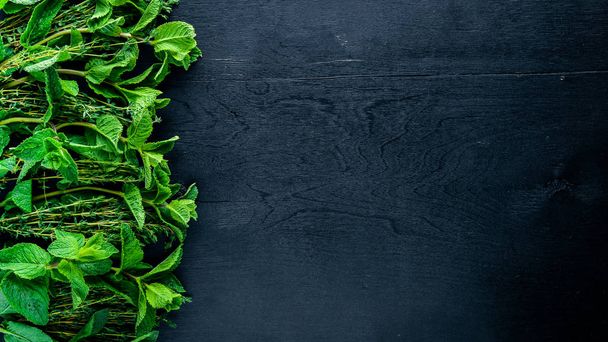 Fresh mint and herbs. On Wooden background. Top view. Free space. - Foto, afbeelding
