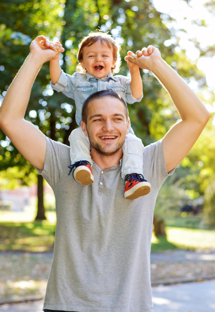 onnellinen isä pitelee poikaansa
 - Valokuva, kuva