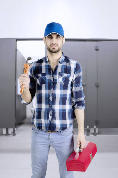Plumber man standing in the toilet - Photo, image