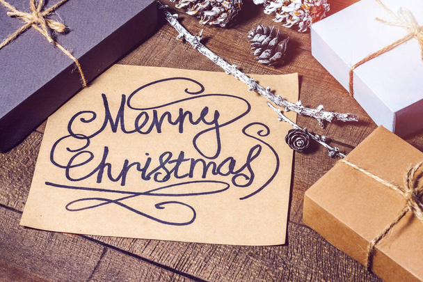 Boxes with gifts, cones, text "Merry Christmas" - Φωτογραφία, εικόνα