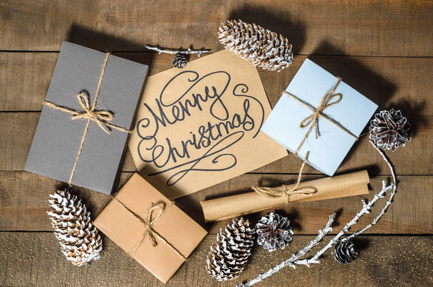Boxes with gifts, cones, text "Merry Christmas" - Photo, Image