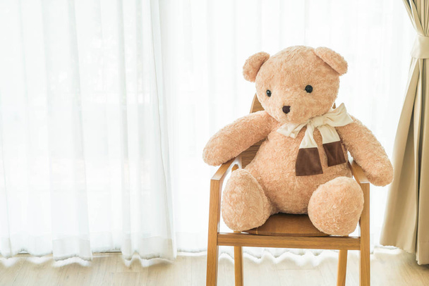 bear doll on chair - Фото, изображение