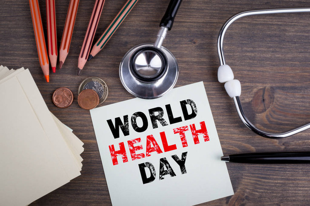Egészségügyi világnap. íróasztal stetascope, háttér, orvosi ellátás - Fotó, kép