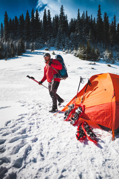 Climber near the tent with snowshoes. - Photo, Image