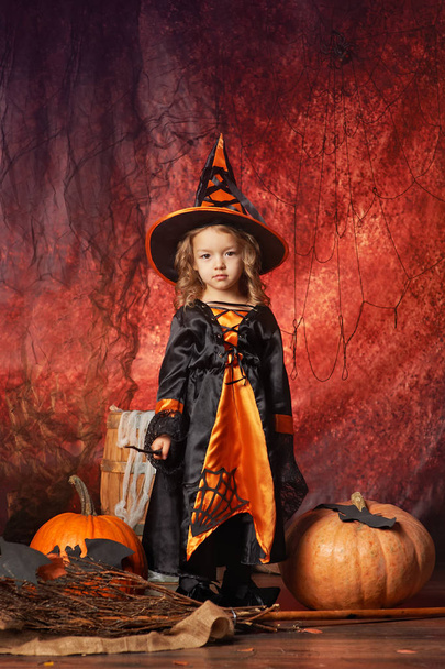 Happy Halloween! beautiful little girl in witch costume with mag - Photo, image