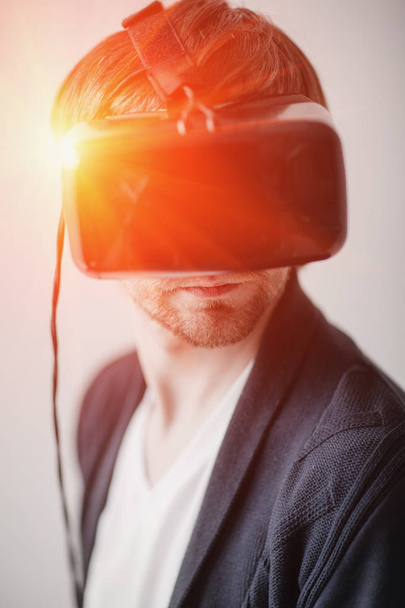 selective focus on face. Handsome man wearing virtual reality glasses isolated  a gray background - Photo, Image