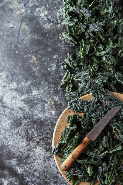 Fresh leaves of Kale salad. Italian Cuisine. Dark background. - Zdjęcie, obraz