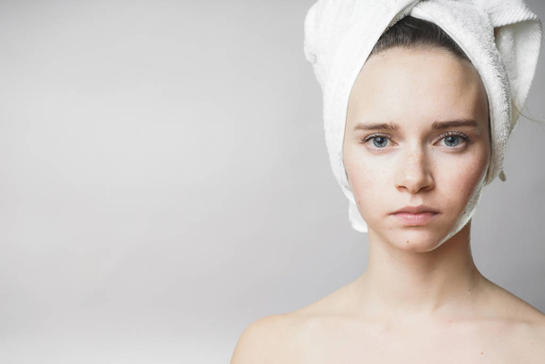 Beautiful woman with towel on the head looking to camera,smile - Фото, изображение
