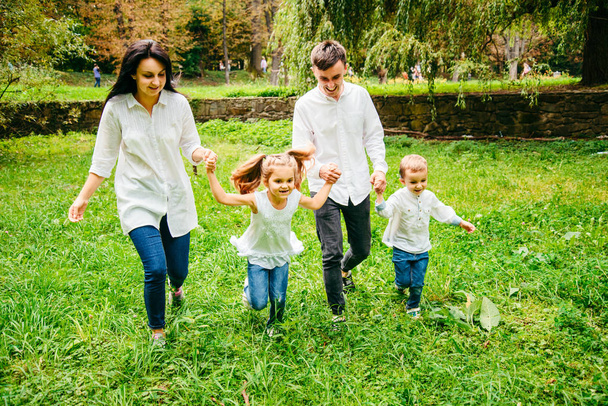 happy family running in city park - Valokuva, kuva