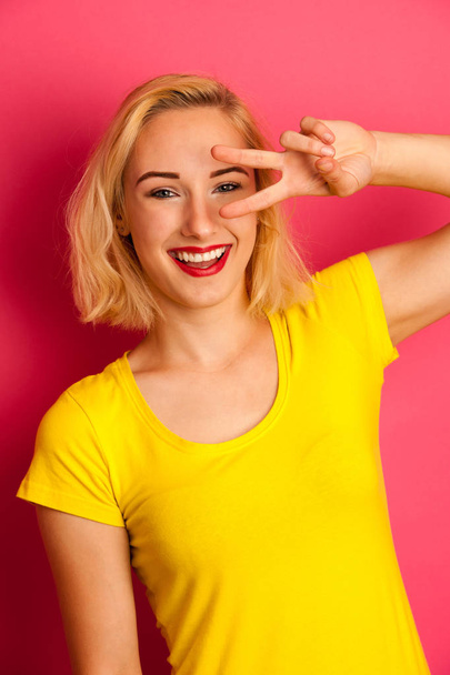 attractive funky teenage girl in yellow t shirt over vibrant pin - Photo, image