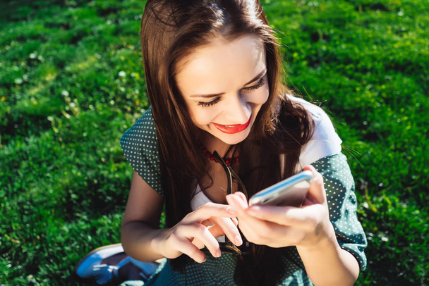 Texting woman,surprised,grass summer background - Φωτογραφία, εικόνα