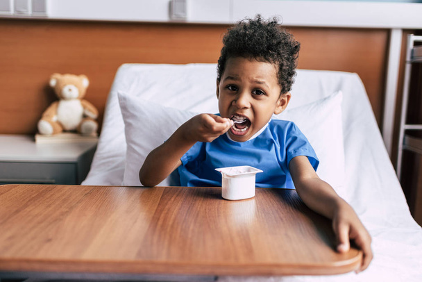 african american boy eating yogurt  - Photo, Image