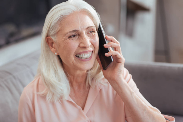 Joyful senior woman talking on smart phone - Foto, Bild